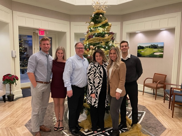 Kilway family standing in front of a Christmas Tree
